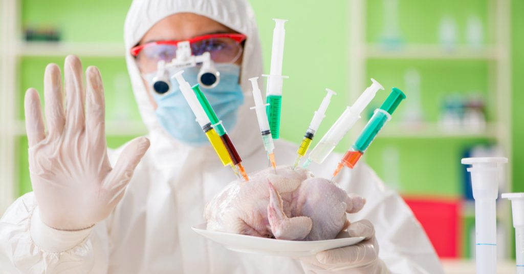 Man-in-lab-with-syringes-stuck-into-a-chicken-Weird-Science-Bad-Stockshots-Under-the-Microscope-Volume-1
